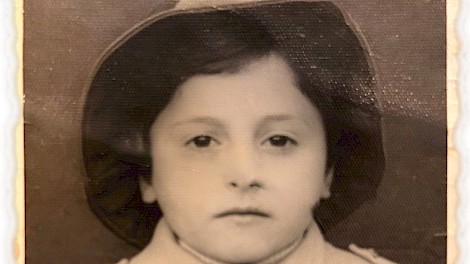 Maria, around four years old, is shown here in her school uniform. During Communism preschool children were called “Falcons of the Motherland.”