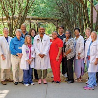 Members of the Tumor Board gather for bimonthly meetings at CHRISTUS St. Michael Hospital. (L-R) Jessica Smallwood, Dr. Malcolm Smith, Dr. Bryan Griffin, Dr. Reginald Baptiste, Yolanda Bone, Charlotte McKamie, Dr. Charles Matthews, Dr. Daphne Taylor, Dr. Sunil Patel,  Jowana Billingly, Lakecia Washington, Brandy Smith, Dr. Beth Peterson, and Dr. Gary Engstrom. photo by Matt Cornelius